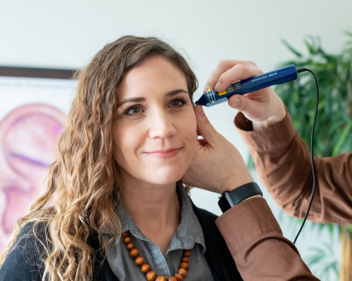 Pointoselect Treatment - Ear- Clinic Practitioner Using Pointoselect Micro-current device on patient's ear